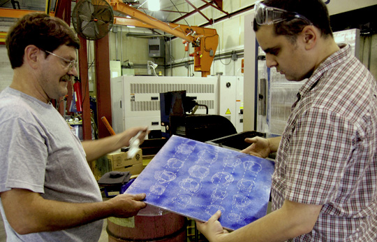 paul and roy examining first successful plate