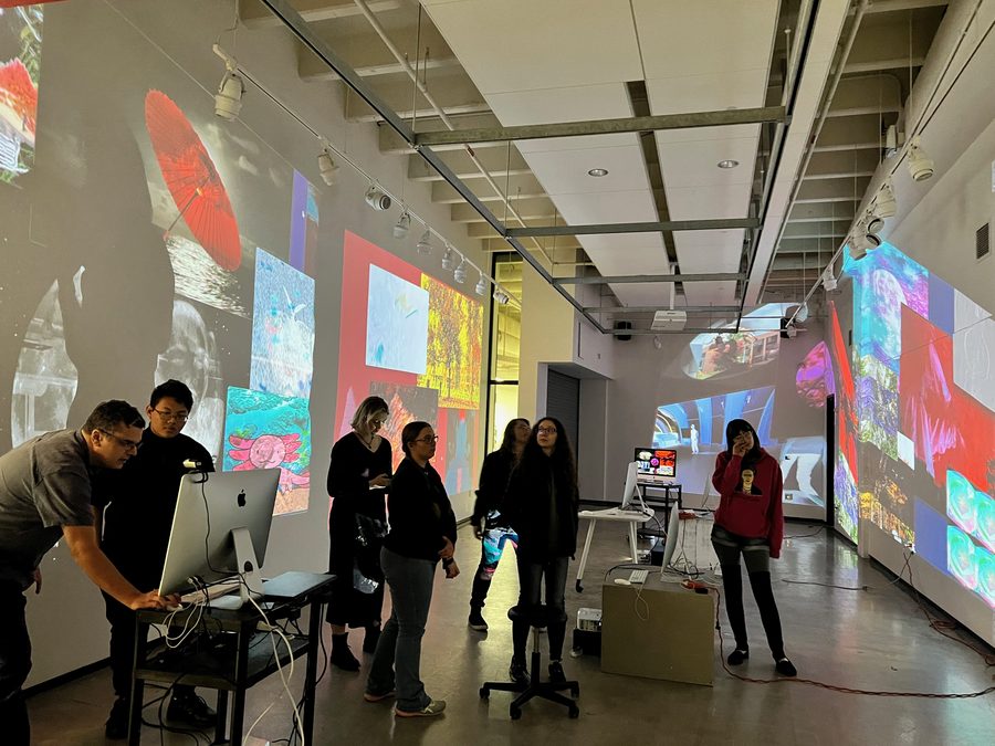Participants working within an immersive projection installation covering multiple walls